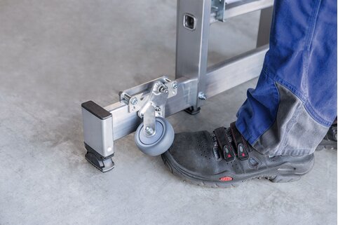 Échelle de Munk Günzburger Steigtechnik avec fonction "roll-bar" qui peut être activée avec le pied. | © MUNK GmbH