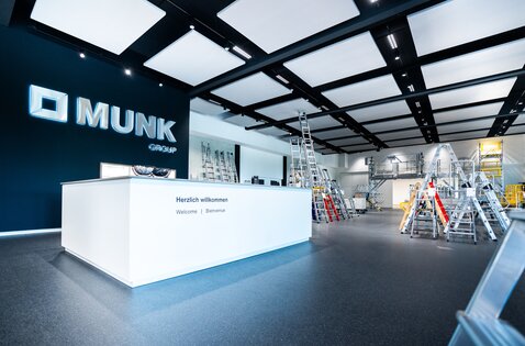 View of the MUNK Customer Centre with reception desk and displayed ladders in the background